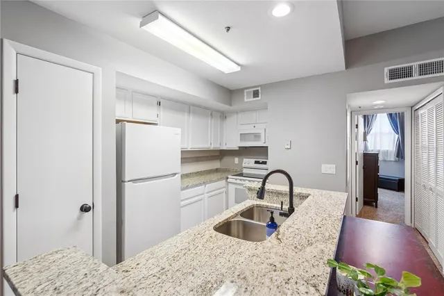a kitchen with a refrigerator and a sink