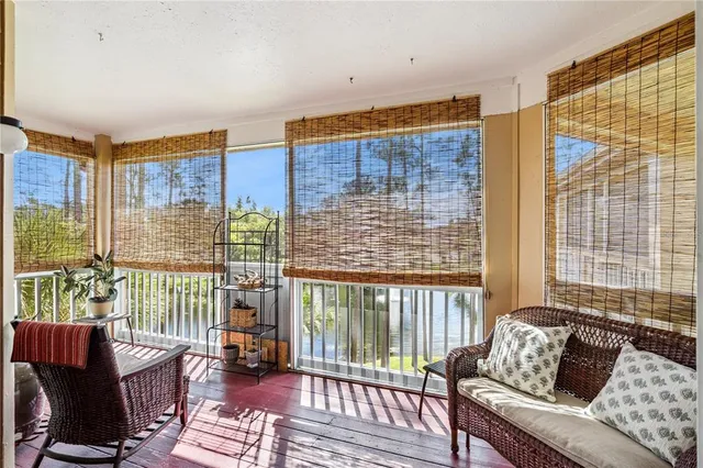 a living room with furniture and a floor to ceiling window