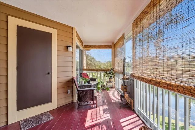 a view of a balcony with chairs and wooden floor