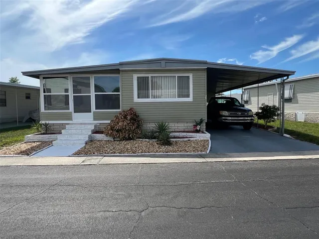 a view of a house that has a car parked in it