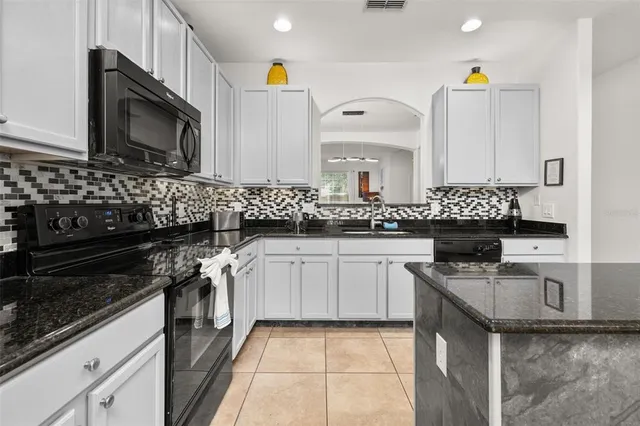 a bedroom with a bed and a flat tv screen on the dresser