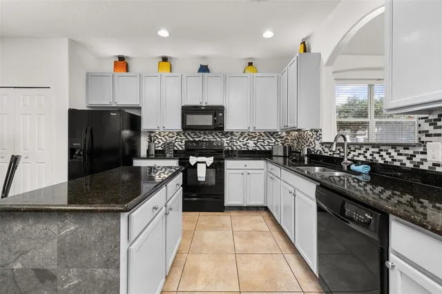 a bed room with a bed and a painting on the wall