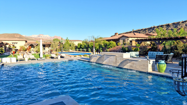 168 South Rancho Santa Fe Virgin, UT 84779 - Photo 47 of 58 Expansive pool with integrated water features, a separate wading pool, and a stone-tiled spa