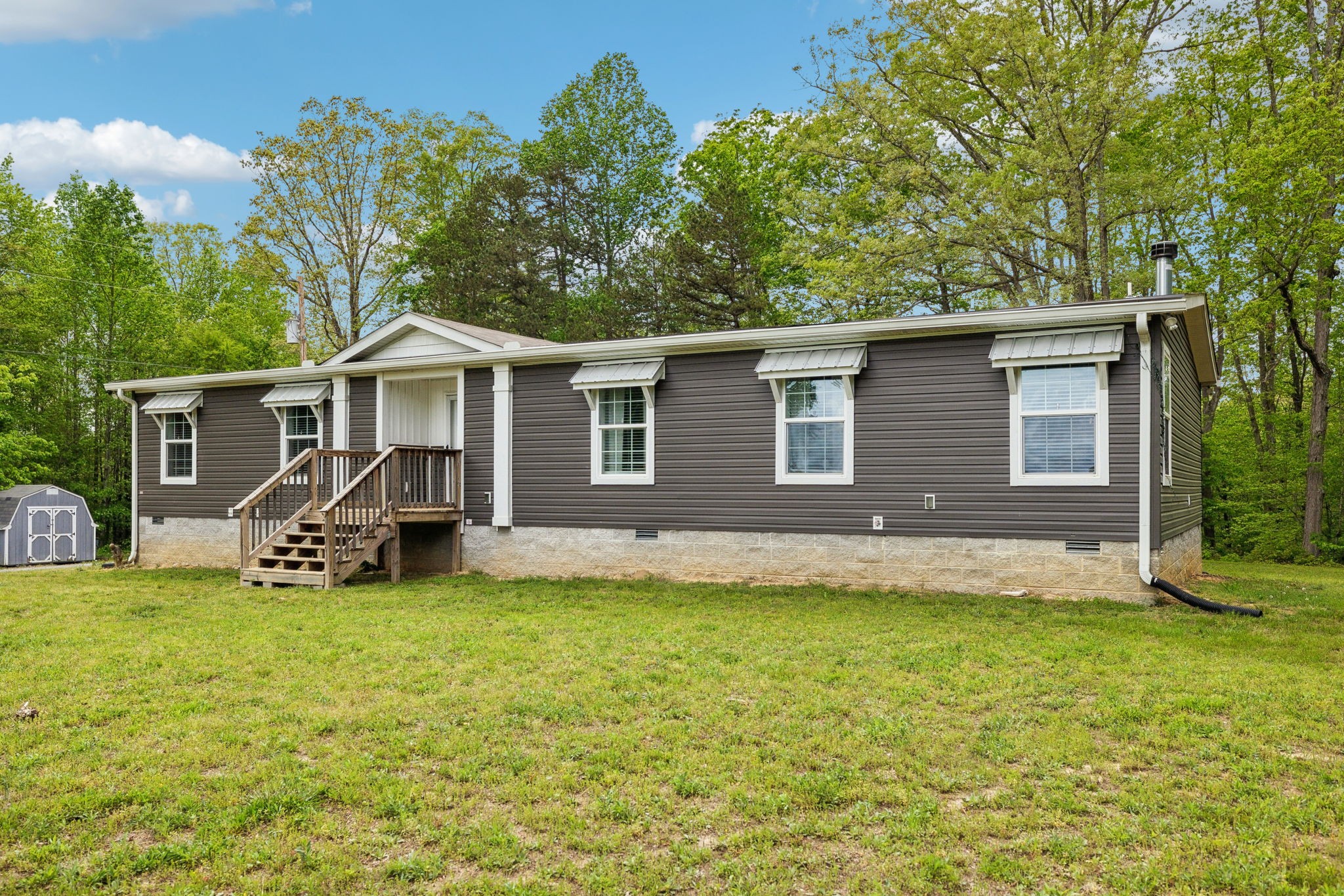 2182 New Home Road Smithville, TN 37166 - Photo 1 of 67 a view of a house with a yard and sitting area