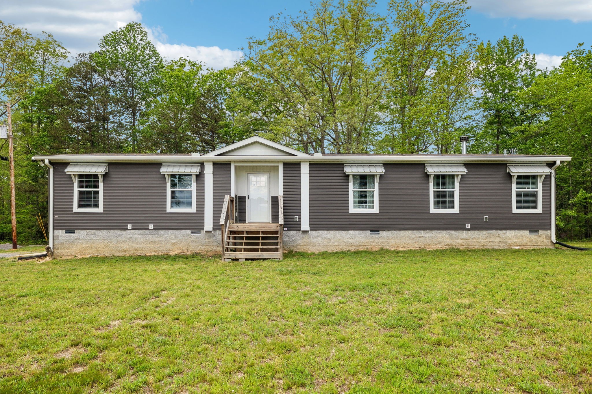 2182 New Home Road Smithville, TN 37166 - Photo 2 of 67 a front view of a house with a garden and yard