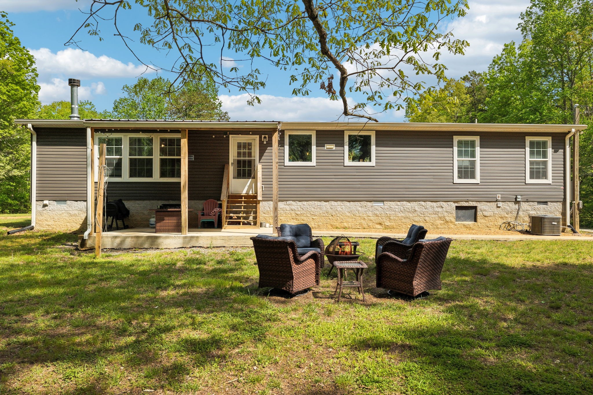 2182 New Home Road Smithville, TN 37166 - Photo 45 of 67 a backyard of a house with yard table and chairs