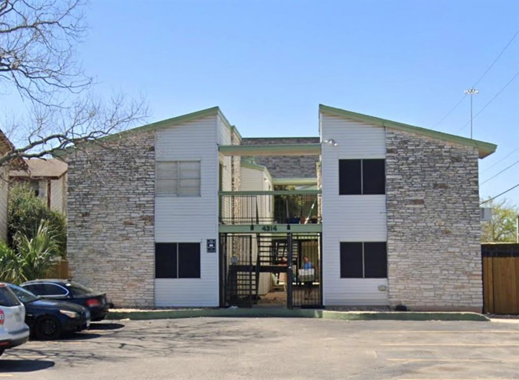 a front view of a house with parking space