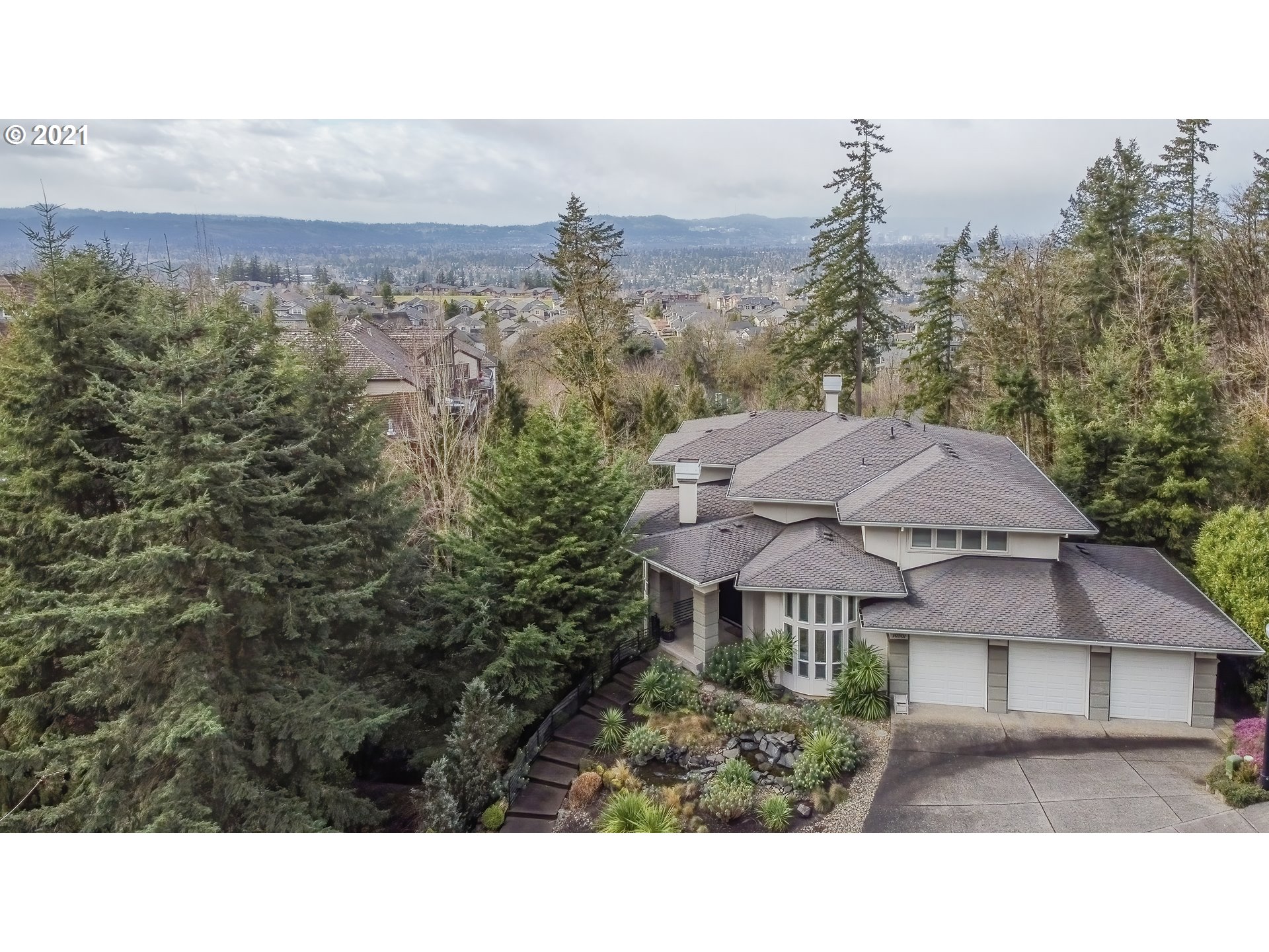 10301 Southeast Crescent Ridge Loop Happy Valley, OR 97086 - Photo 1 of 32 a view of a house with a yard and trees