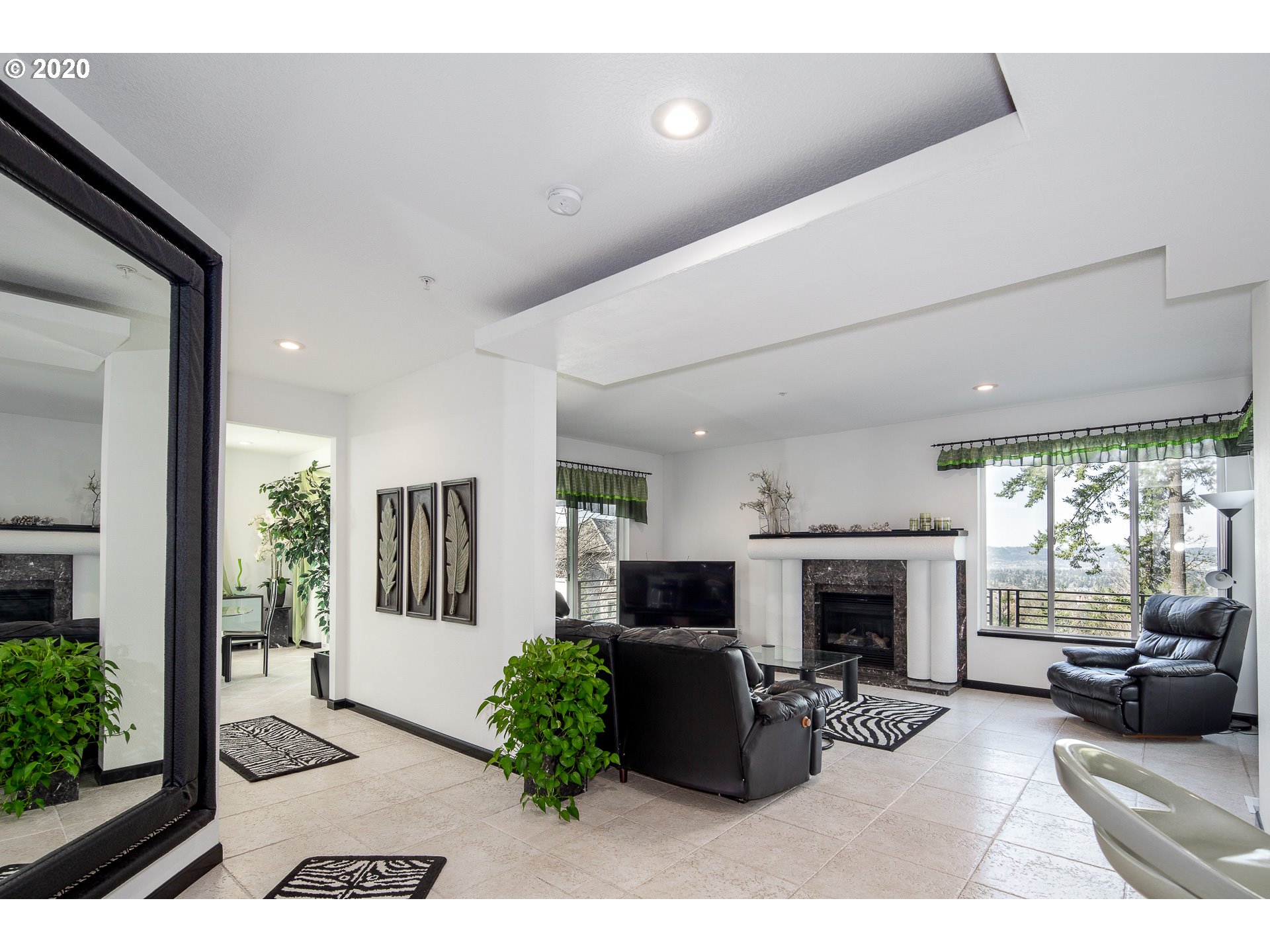 10301 Southeast Crescent Ridge Loop Happy Valley, OR 97086 - Photo 11 of 32 a living room with furniture a flat screen tv and a fireplace