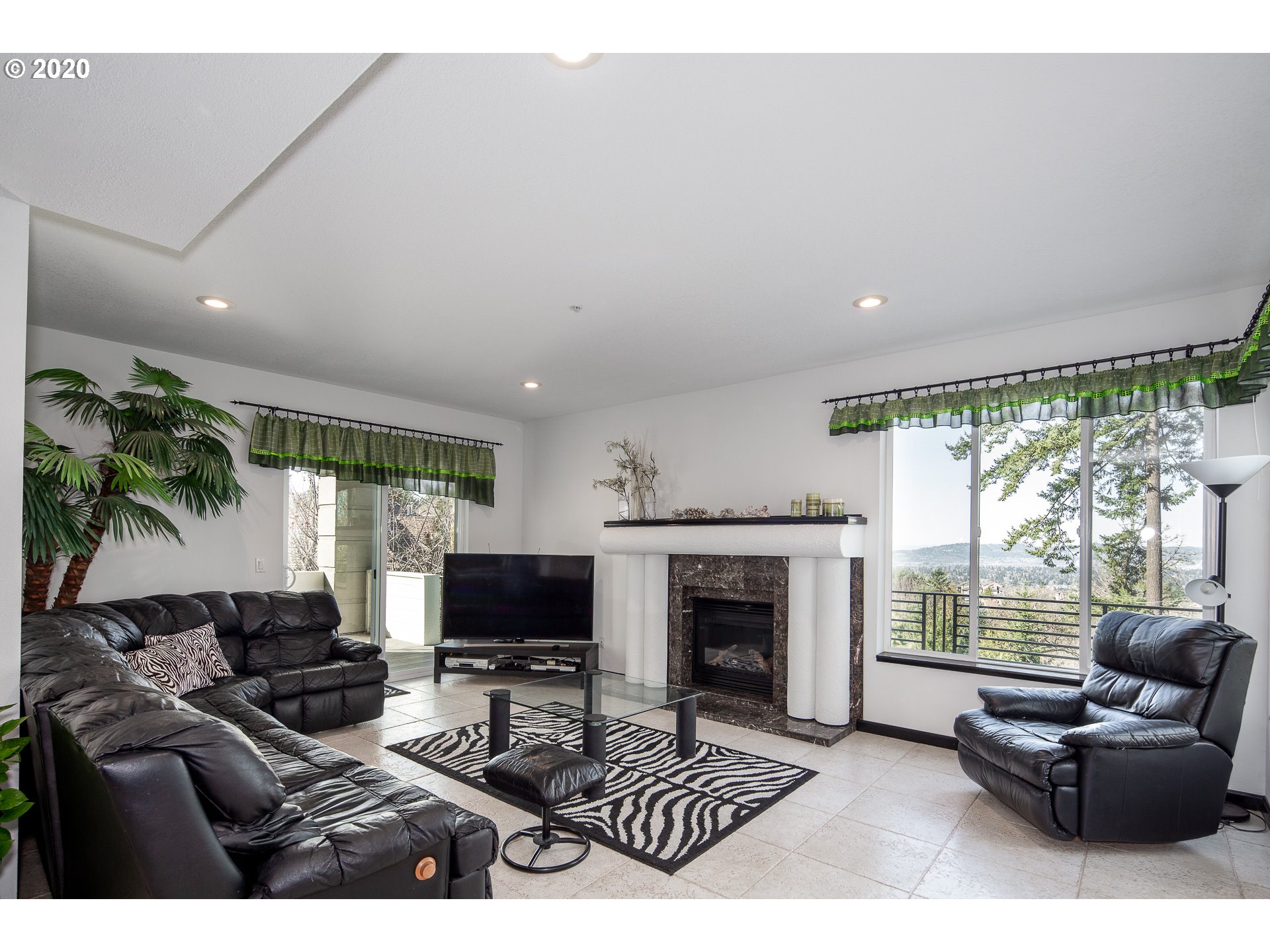 10301 Southeast Crescent Ridge Loop Happy Valley, OR 97086 - Photo 12 of 32 a living room with furniture a flat screen tv and a fireplace