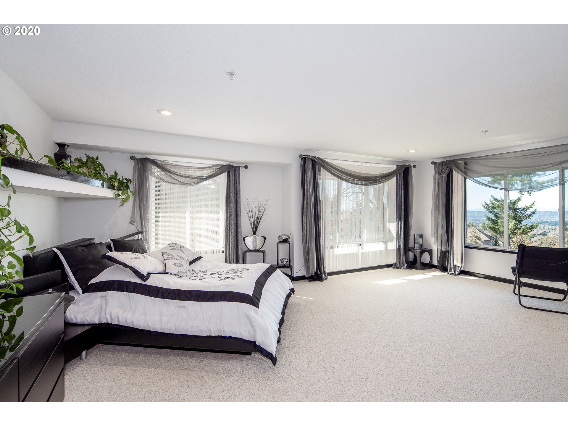 10301 Southeast Crescent Ridge Loop Happy Valley, OR 97086 - Photo 19 of 32 a bedroom with bed couch and window