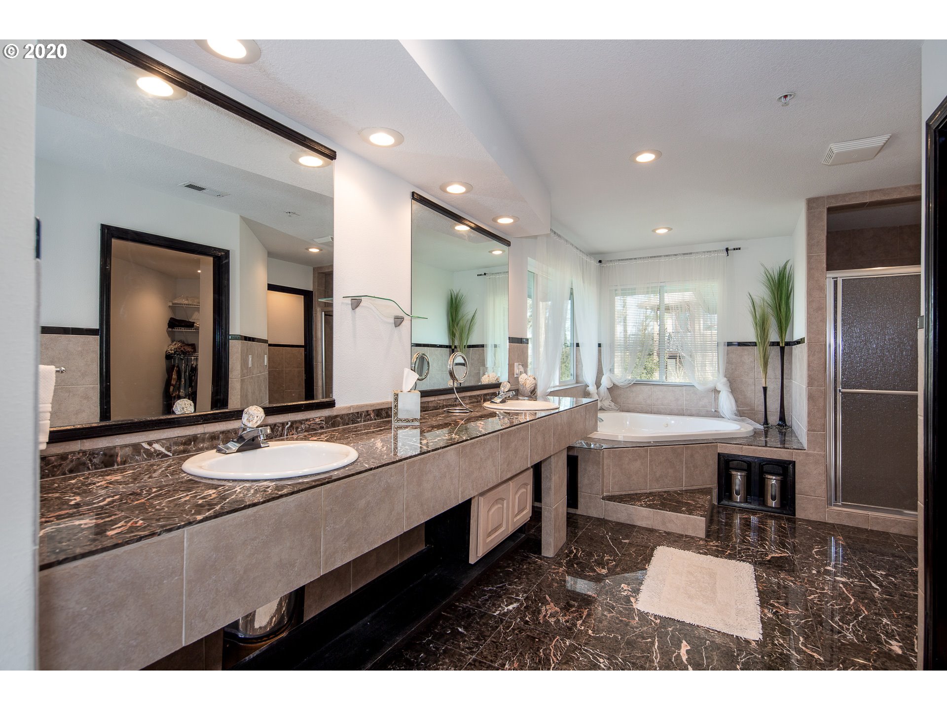 10301 Southeast Crescent Ridge Loop Happy Valley, OR 97086 - Photo 21 of 32 a bathroom with a sink a granite counter and a view of living room