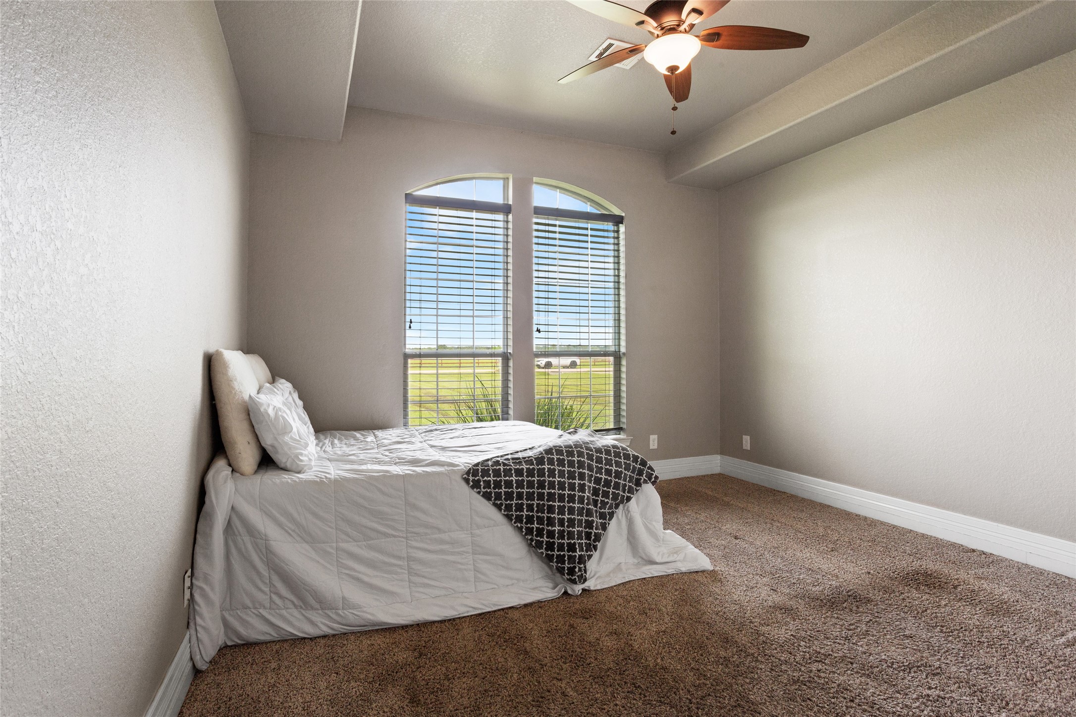 7842 Pebble Hill Lane Rosharon, TX 77583 - Photo 21 of 33 a bedroom with a large bed and a chandelier