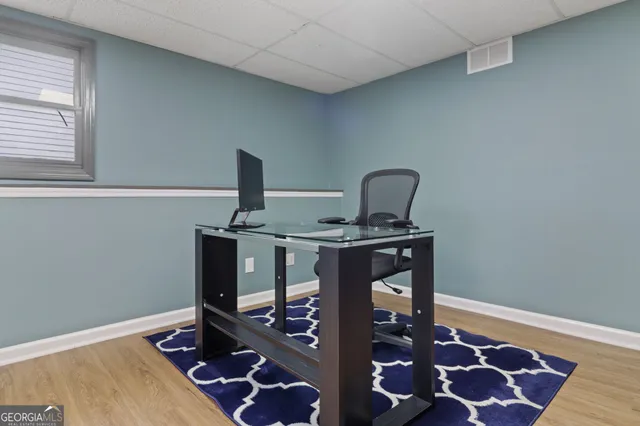 a bed sitting in a bedroom next to a window