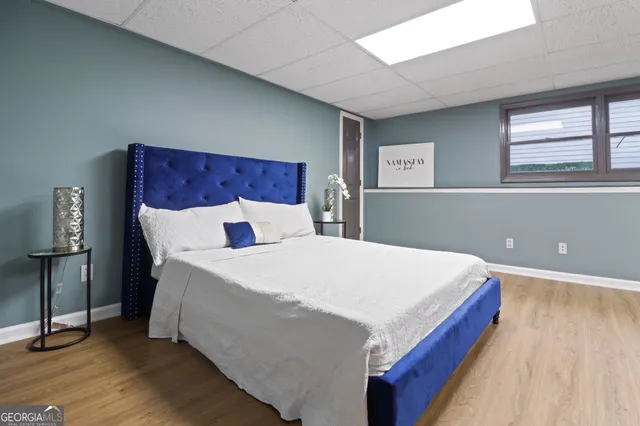 a bedroom with a bed lamp and dresser