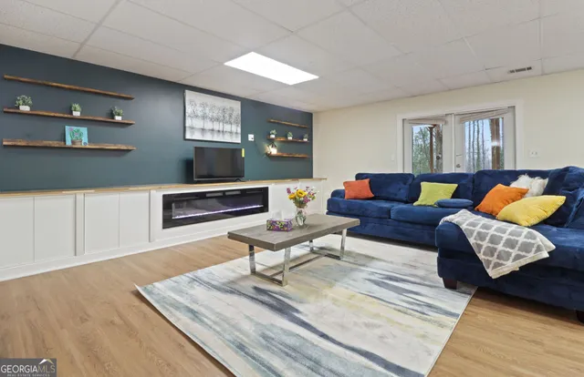 a living room with furniture and wooden floor