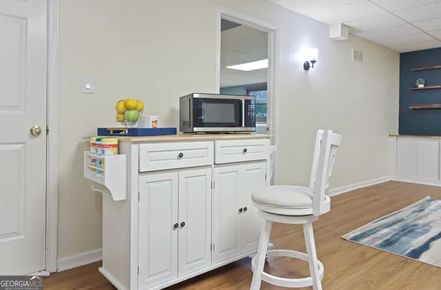 a bedroom with a bed a table and a potted plant
