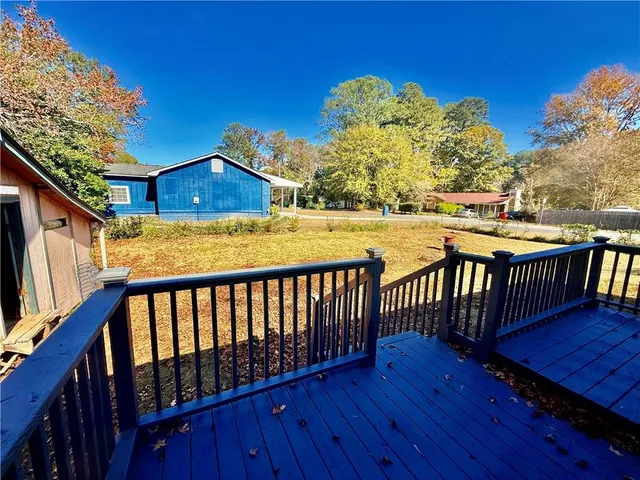a balcony with wooden floor and outdoor space