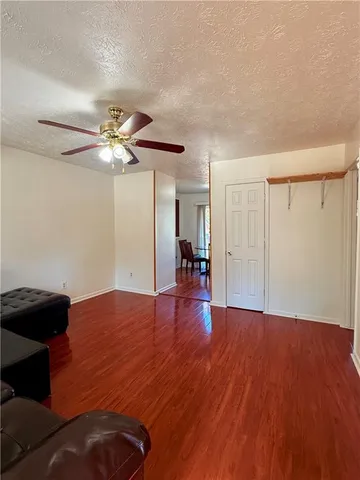 a view of livingroom with hardwood floor and ceiling fan