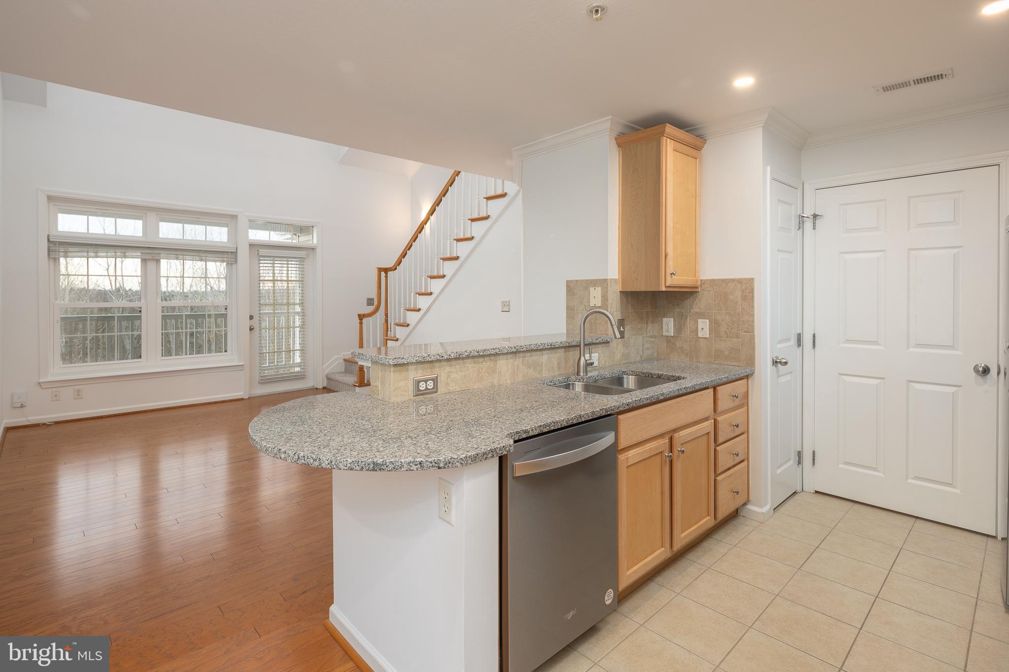 512 Sunset View Terrace Southeast, Unit 402 Leesburg, VA 20175 - Photo 14 of 30 a kitchen with stainless steel appliances granite countertop a sink and a granite counter tops