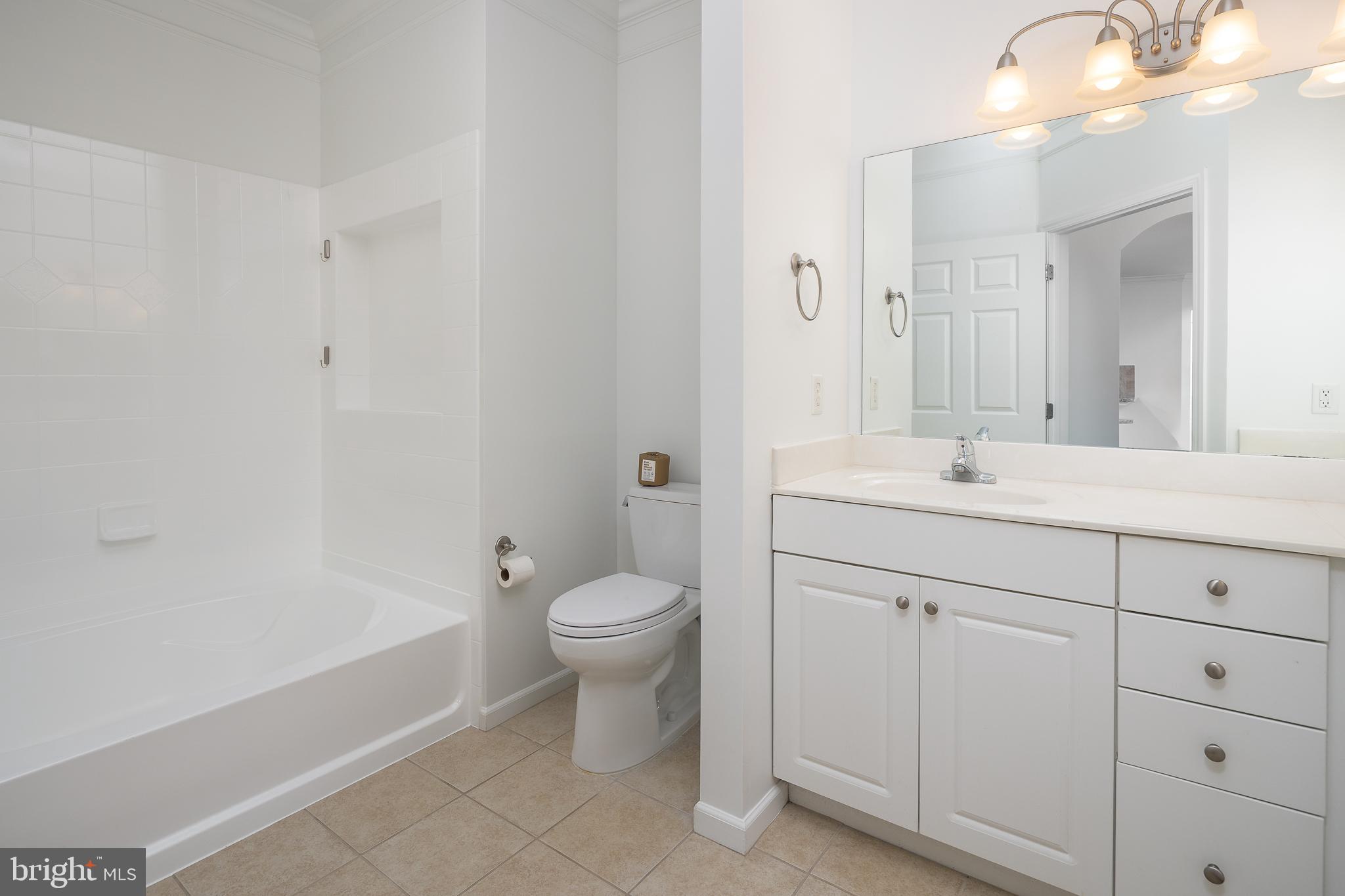 512 Sunset View Terrace Southeast, Unit 402 Leesburg, VA 20175 - Photo 17 of 30 a bathroom with a sink a toilet and shower
