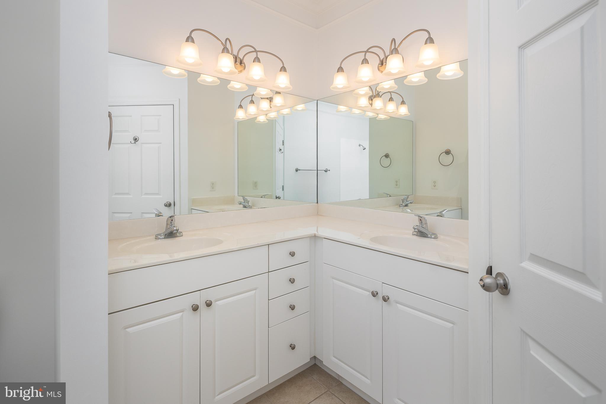 512 Sunset View Terrace Southeast, Unit 402 Leesburg, VA 20175 - Photo 18 of 30 a bathroom with a double vanity sink mirror and