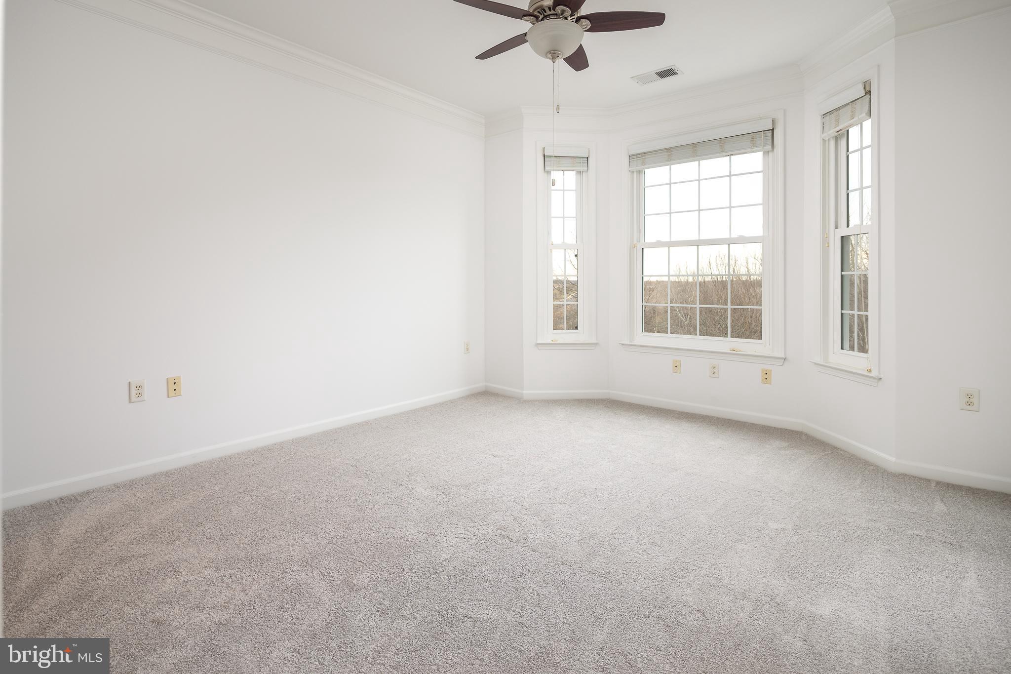 512 Sunset View Terrace Southeast, Unit 402 Leesburg, VA 20175 - Photo 19 of 30 an empty room with a empty space and windows
