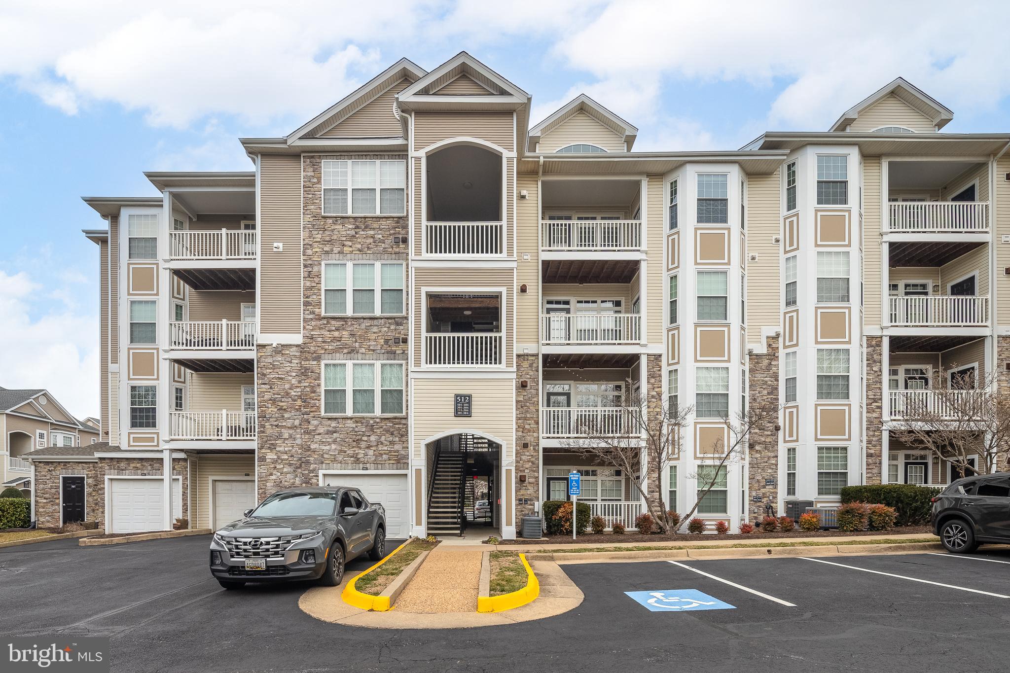 512 Sunset View Terrace Southeast, Unit 402 Leesburg, VA 20175 - Photo 2 of 30 a view of a parked cars in front of a building