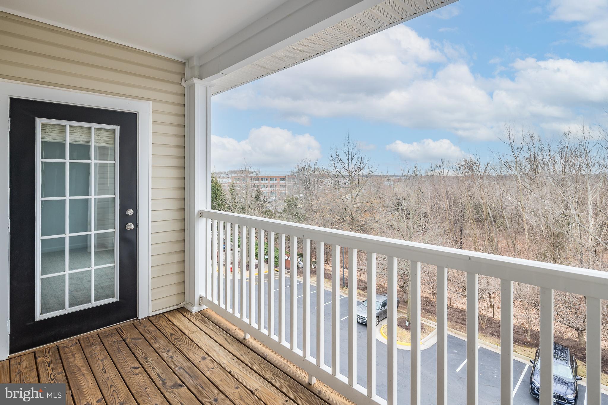 512 Sunset View Terrace Southeast, Unit 402 Leesburg, VA 20175 - Photo 22 of 30 a view of a balcony with wooden floor
