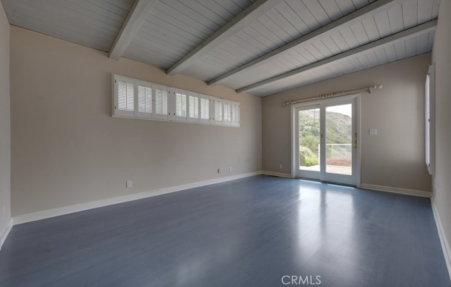 122 Spindrift Lane Rancho Palos Verdes, CA 90275 - Photo 12 of 17 an empty room with wooden floor and windows