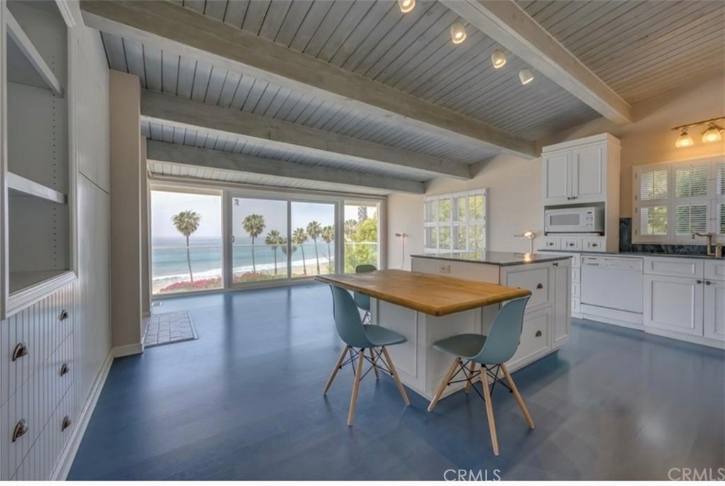 122 Spindrift Lane Rancho Palos Verdes, CA 90275 - Photo 2 of 17 a kitchen with granite countertop a table chairs sink and cabinets