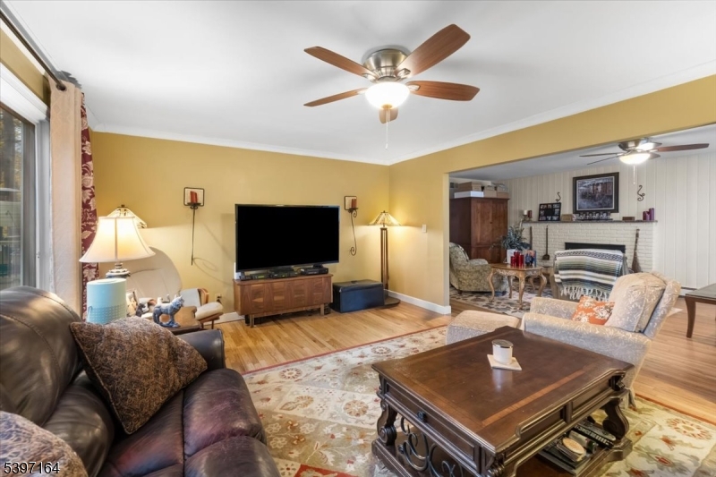 53 Pequot Road Ringwood, NJ 07456 - Photo 13 of 35 a living room with furniture a flat screen tv and kitchen view