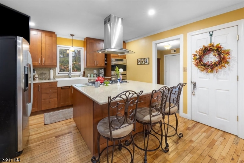 53 Pequot Road Ringwood, NJ 07456 - Photo 18 of 35 a kitchen with a table chairs refrigerator and microwave