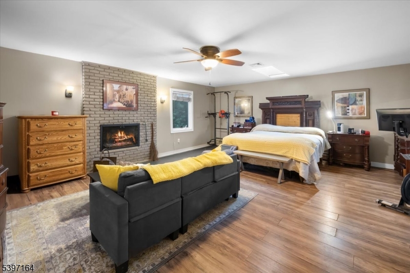 53 Pequot Road Ringwood, NJ 07456 - Photo 21 of 35 a bedroom with furniture and a fireplace