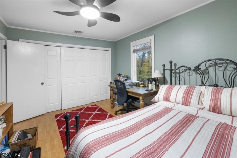 53 Pequot Road Ringwood, NJ 07456 - Photo 26 of 35 a bedroom with a bed and a chandelier