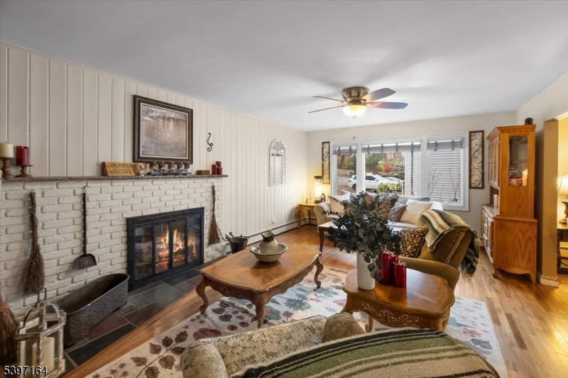 53 Pequot Road Ringwood, NJ 07456 - Photo 9 of 35 a living room with furniture fireplace and a window