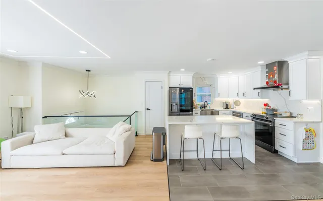 a large kitchen with stainless steel appliances lots of counter space and a sink