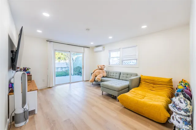 a bedroom with furniture and a flat screen tv