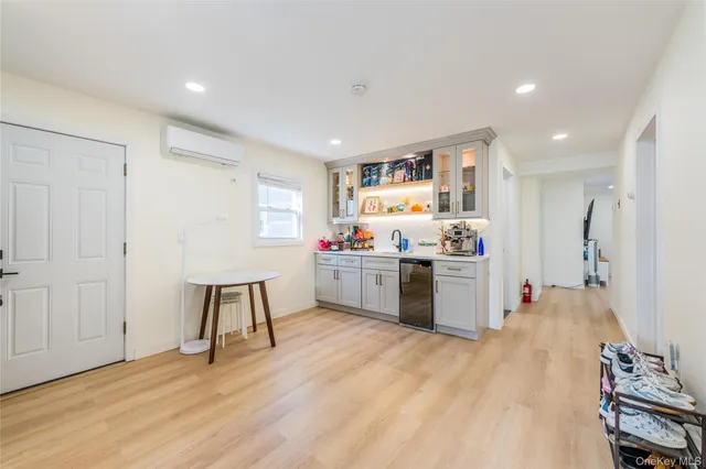 a kitchen with a sink cabinets and wooden floor