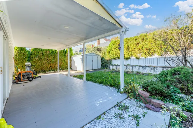 a view of a back yard with porch and furniture