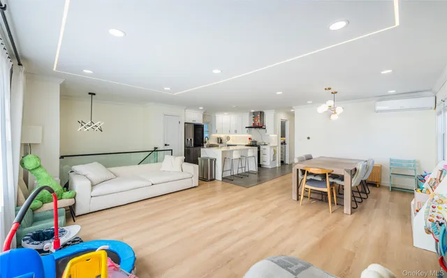 a living room with furniture kitchen view and a dining table