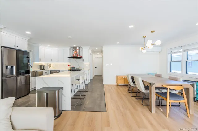 a large kitchen with a table and chairs
