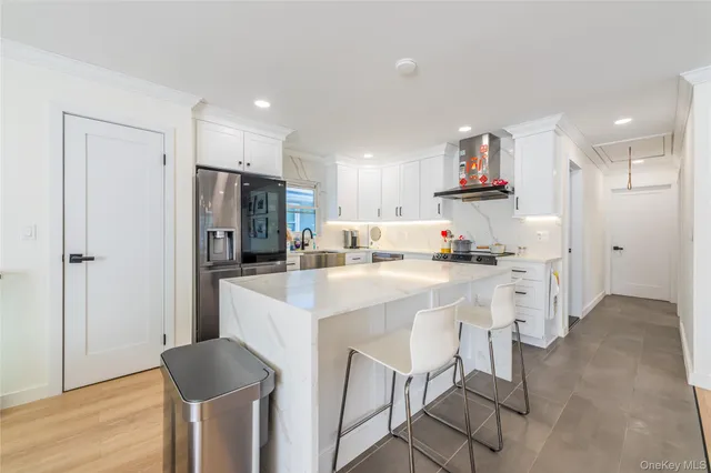 a kitchen with kitchen island cabinets and refrigerator