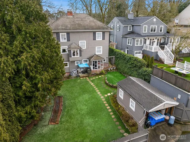 an aerial view of a house with swimming pool garden and patio