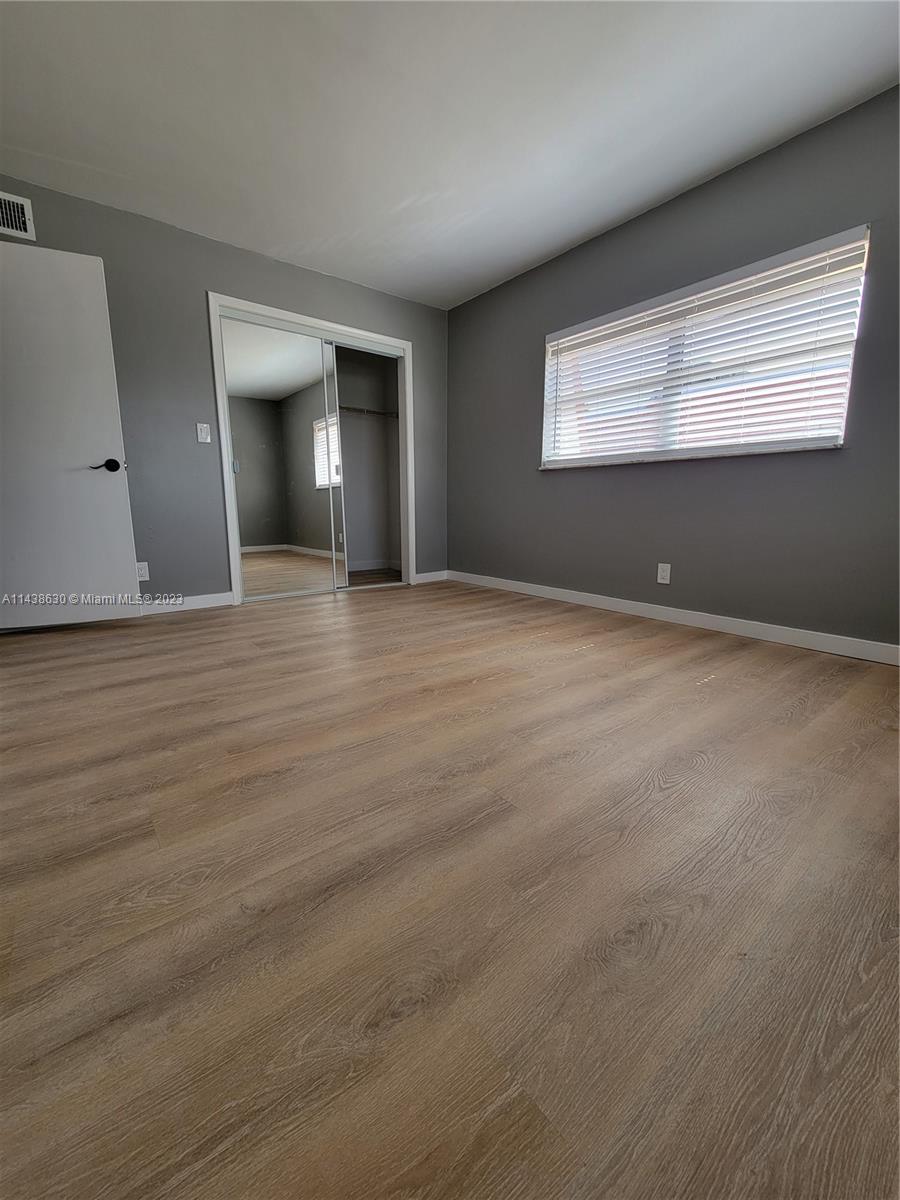 5321 Northwest 27th Street, Unit A4 Lauderhill, FL 33313 - Photo 12 of 19 a view of an empty room with window and wooden floor