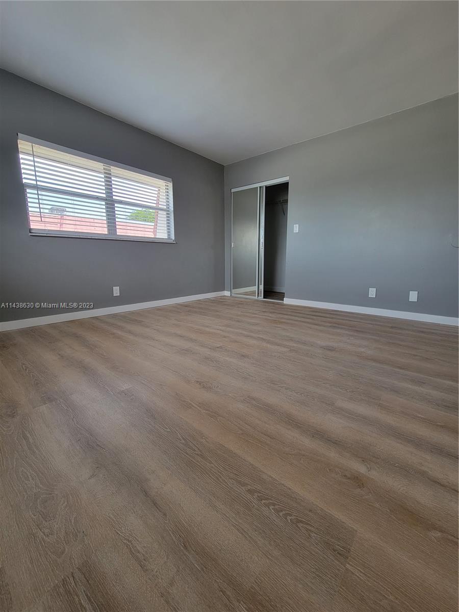 5321 Northwest 27th Street, Unit A4 Lauderhill, FL 33313 - Photo 14 of 19 a view of an empty room with window and wooden floor