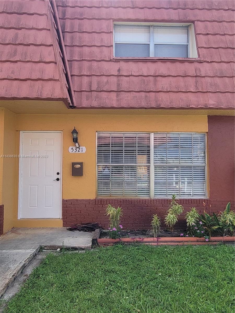 5321 Northwest 27th Street, Unit A4 Lauderhill, FL 33313 - Photo 17 of 19 a backyard of a house with lots of green space and wooden fence