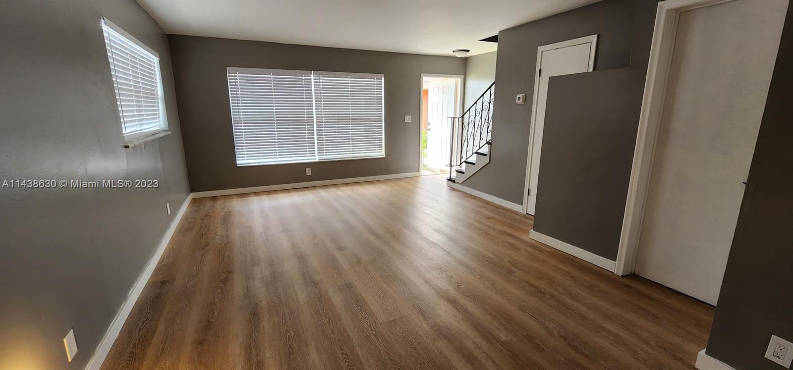 5321 Northwest 27th Street, Unit A4 Lauderhill, FL 33313 - Photo 4 of 19 a view of an empty room with wooden floor and a window