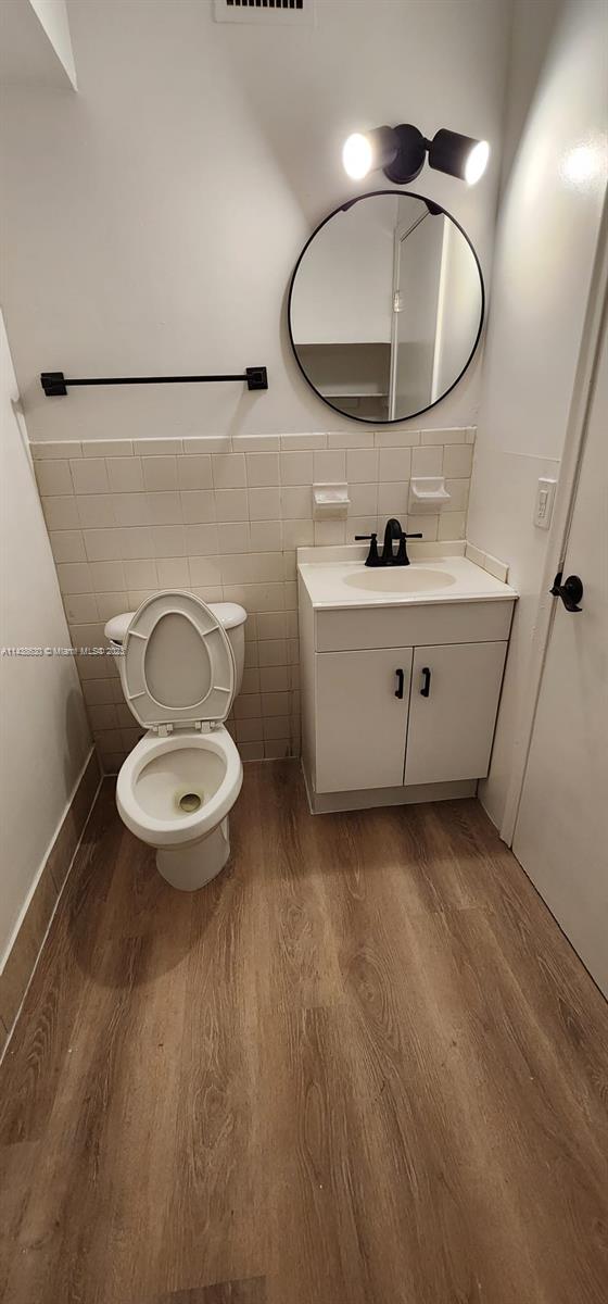 5321 Northwest 27th Street, Unit A4 Lauderhill, FL 33313 - Photo 5 of 19 a bathroom with a sink mirror vanity and toilet