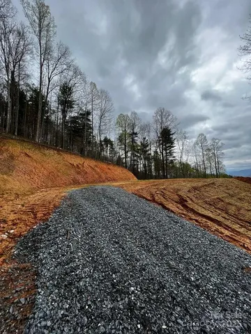 a view of a yard with wooden fence